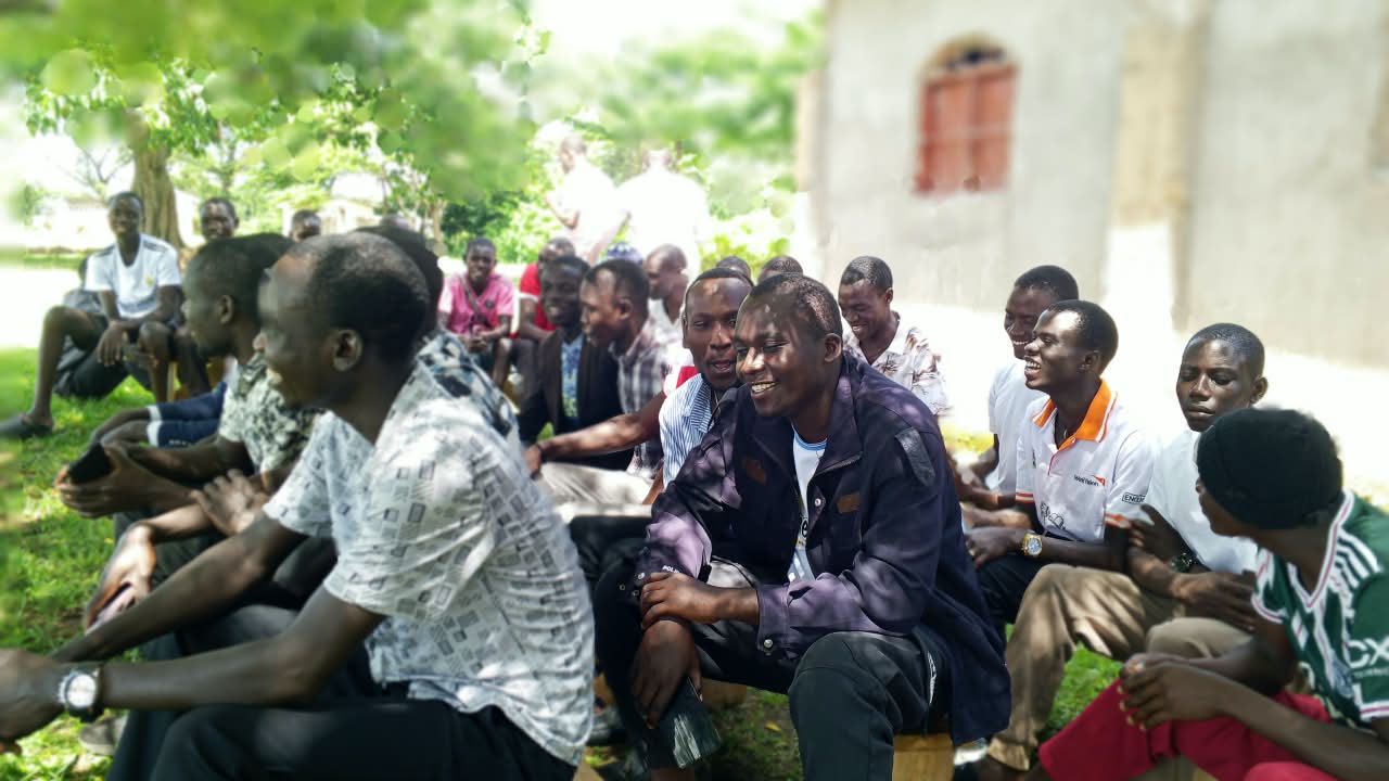 Young men laughing together at a community session