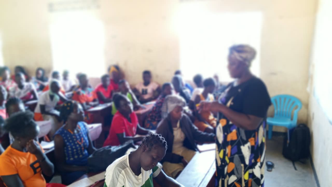 Indoor group health education session with many young people