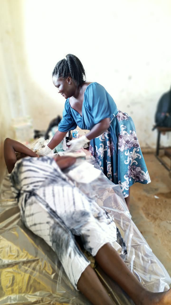 Health worker conducting clinical examination