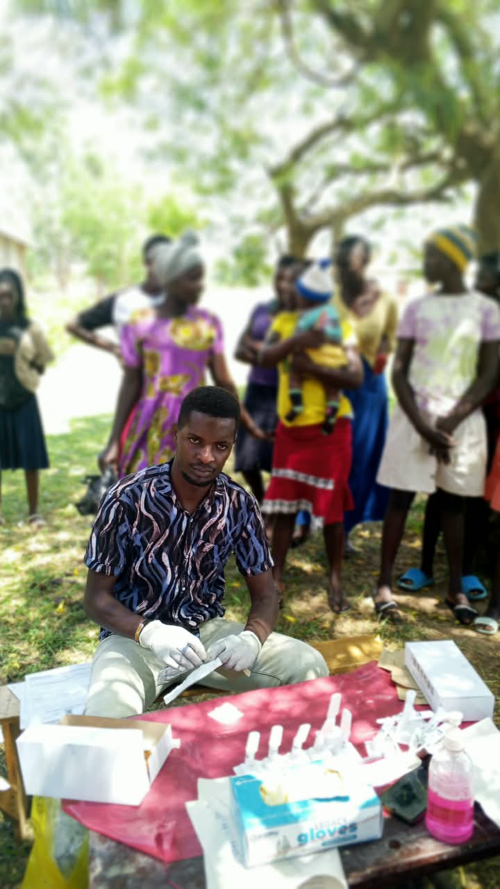 Health worker and community members at an outdoor outreach session