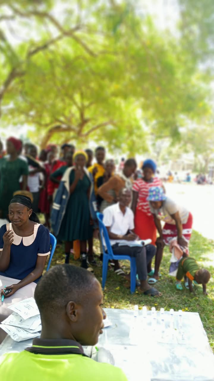 Young parents waiting at health testing station outdoors