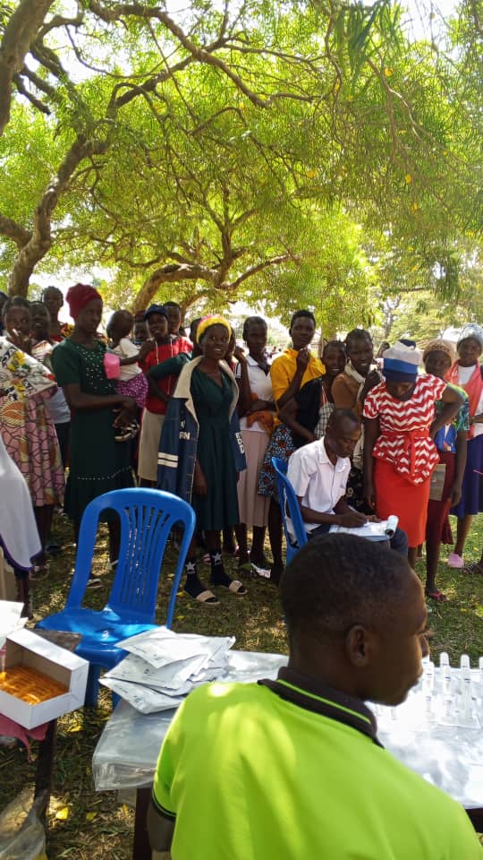 Health worker conducting HIV testing at a community outreach session in Tororo District